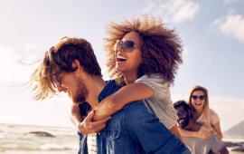 Young couples wearing sunglasses on the beach