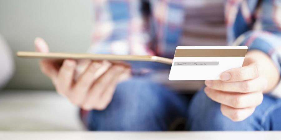 Person with ipad and credit card