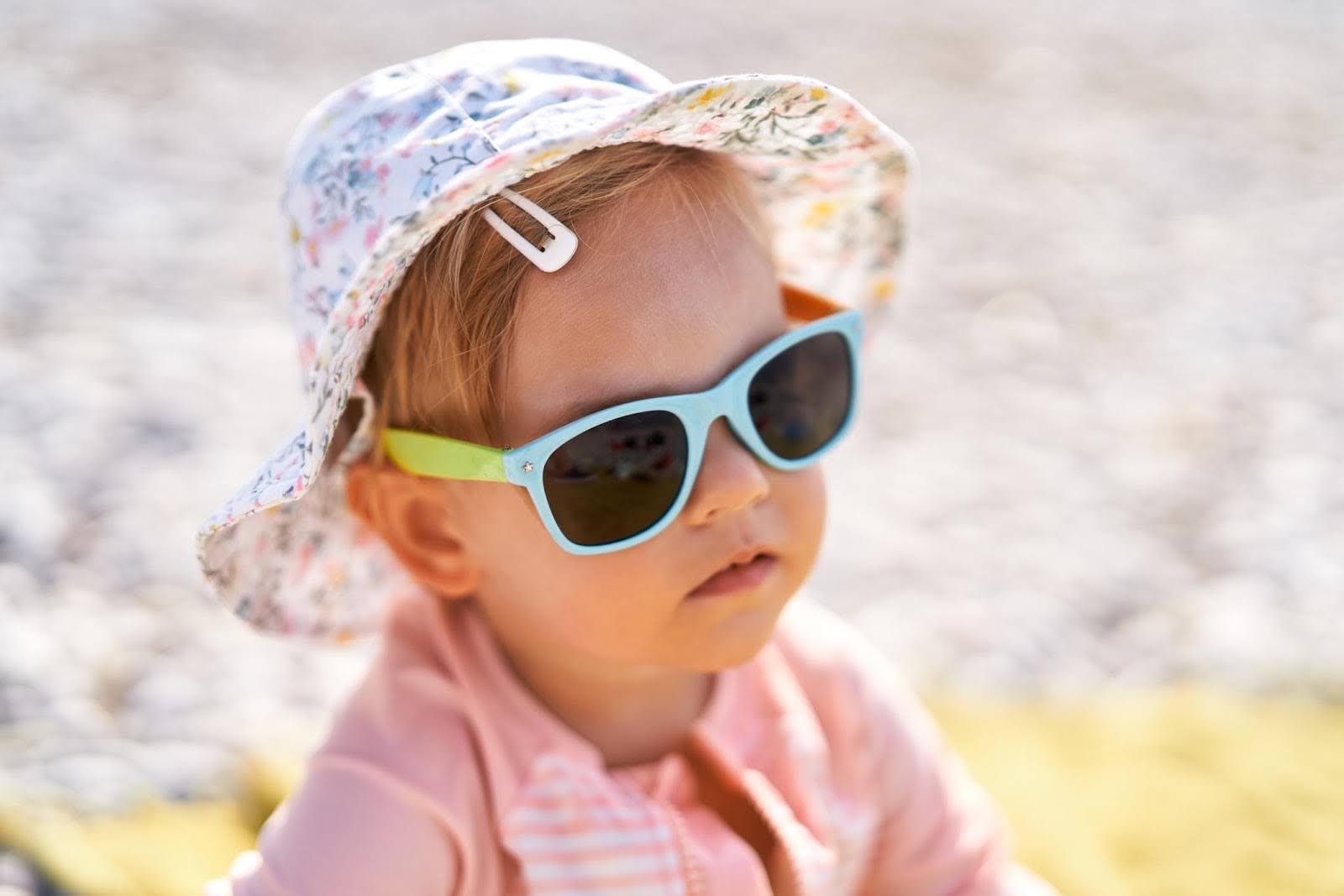 Infant girl soaking in the sun at a beach