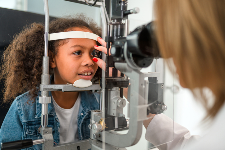 Young girl at the optometrist's office having an eye exam.