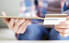 Person with ipad and credit card