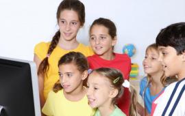 children in front of a computer