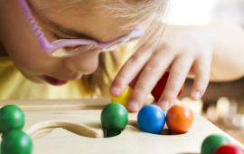 Little girl with glasses engages in vision therapy