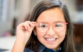 Smiling girl with new glasses