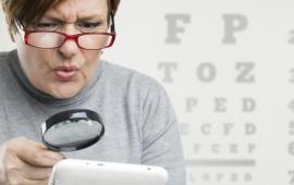 Woman reading with a magnifying glass