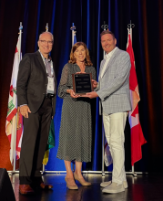 Dr. Deborah Jones receiving the presidents award from CAO past presidents Dr. Harry Bohnsack and Dr. Michael Nelson