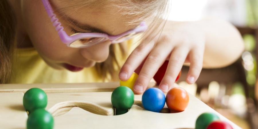 Little girl with glasses engages in vision therapy