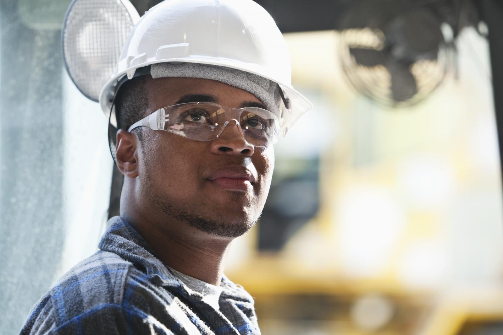 Young man wearing helmet and safety glasses
