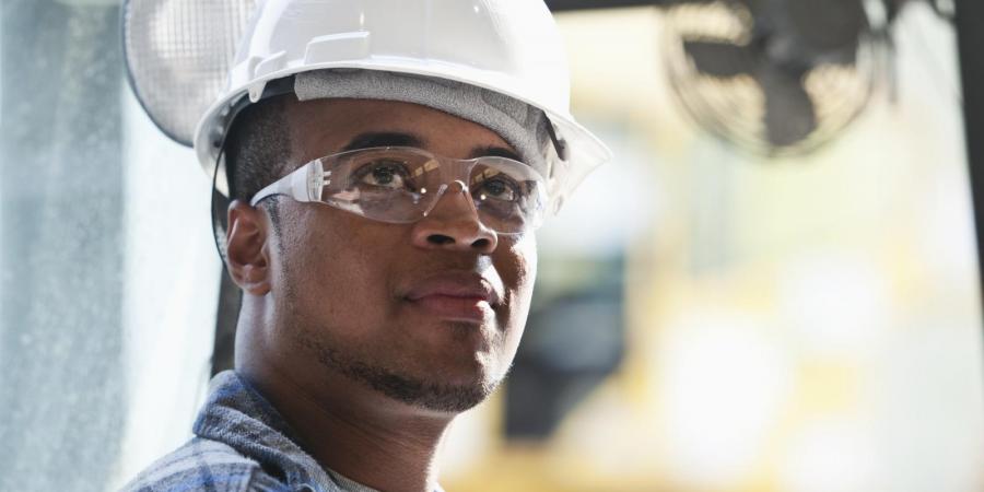 Young man wearing helmet and safety glasses