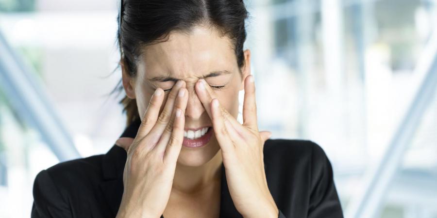 Woman rubbing her dry eyes