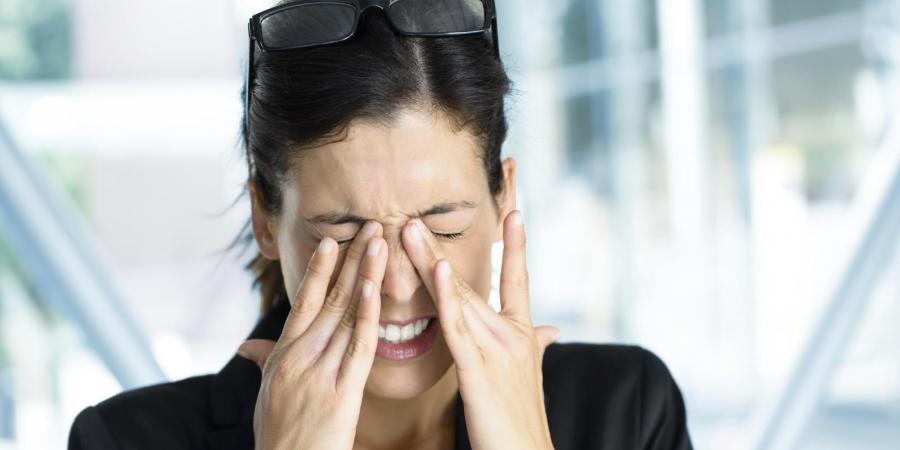 Woman rubbing her dry eyes