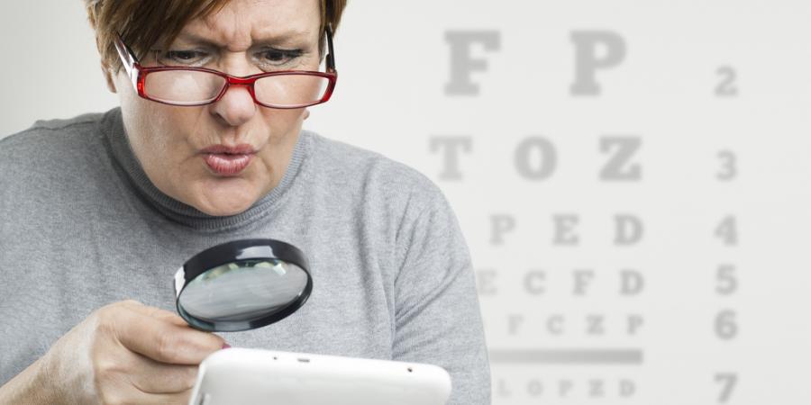 Woman reading with a magnifying glass